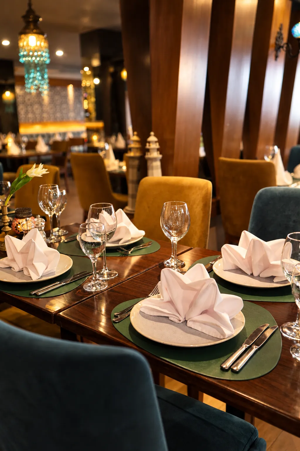 Dining room set for dinner beneath glowing lanterns
